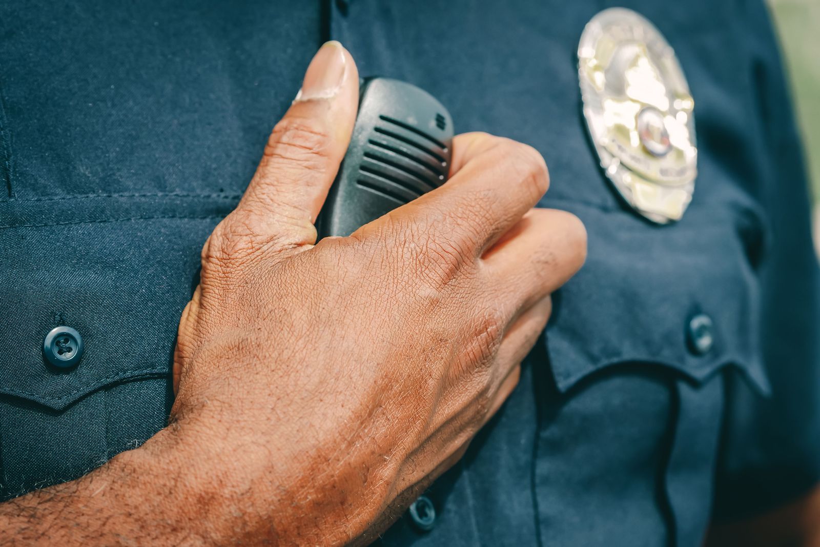 Police officer's badge and shoulder radio